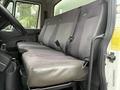 A gray leather bench seat inside a 2014 International TerraStar with seat belts and a textured pattern