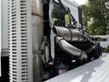 A 2012 Autocar Xpert is shown with visible exhaust pipes and metal components along the side of the vehicle