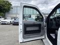 A 2015 Ford F-350 SD with its driver's side door open showing the interior door handle and panel details