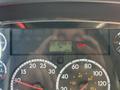 Dashboard display of a 2015 Freightliner M2 106 showing odometer reading of 201288.4 km and engine warning light illuminated