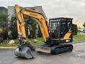 A 2022 Hyundai R55-9A excavator with a yellow and black color scheme featuring a bucket attachment in an upright position