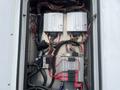 View of a 2016 Chevrolet Express electrical panel showing various wires and electronic components with a focus on circuit boards and relays