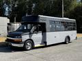 A 2019 Chevrolet Express bus with a black and silver exterior featuring large windows and a step for entry