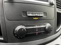 The interior control panel of a 2023 Mercedes-Benz Metris featuring dials for temperature and air conditioning settings along with a digital display