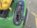 Close-up of the control panel of a 2021 John Deere L Series S featuring toggles for speed and function adjustments