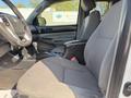 Interior of a 2015 Toyota Tacoma showing the front seats dashboard and gear shift in a gray fabric and trim