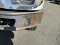 Close-up of the front bumper of a 2007 International 7300 showing rust and wear with exposed metal and a visible tire behind the bumper