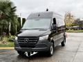 A 2022 Mercedes-Benz Sprinter van in black color with a sleek design and front grille featuring the iconic Mercedes-Benz logo