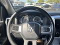 Interior view of a 2011 RAM 1500 showing the steering wheel dashboard and gauges