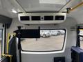 Interior view of a 2017 Chevrolet Express showing the dashboard air vents and overhead controls with a monitor and yellow grab bar visible next to the driver's seat