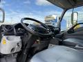Interior view of a 2014 Hino 195 truck showing the driver's seat steering wheel dashboard and gear shift
