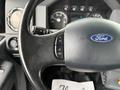 Close-up of the steering wheel and dashboard of a 2015 Ford F750 with the Ford logo and various instrument dials visible
