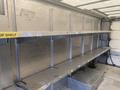 Interior of a 2012 Ford Econoline with metal shelves designed for storage and organization