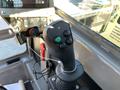 Control joystick of a 2022 TerraMac Tracked Dump featuring buttons in green and black for various functions