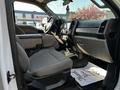 Interior of a 2021 Ford F-550 featuring gray upholstery with a spacious front seat area and a dashboard displaying the Super Duty emblem