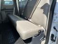 Interior view of a 2008 Ford F-450 SD showing the rear bench seat with light-colored upholstery and seat belts