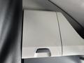 The image shows the interior storage compartment of a 2022 Freightliner Cascadia with a textured surface and a small handle for opening