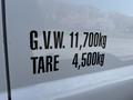 A 2016 Ford F-550 with visible cargo weight specifications reading G.V.W. 11,700kg and TARE 4,500kg on its side panel