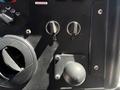 Dashboard controls of a 2019 Freightliner MT45 showing ignition keys and a panel with a round knob and various switches