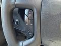 Close-up view of the steering wheel of a 2020 Chevrolet Express featuring buttons for cruise control settings and adjustments