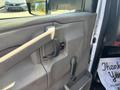 Interior door handle of a 2017 Chevrolet Express with a window control switch and armrest visible