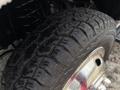 Close-up of a rugged tire from a 2017 Ford Econoline showing deep treads and metallic rim