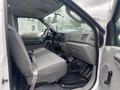 Interior view of a 2003 Ford F-450 SD showing the driver's side with gray fabric seats and a dashboard with various controls and a gear shift
