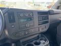 Interior dashboard of a 2019 GMC Savana featuring radio controls air vents and cup holders
