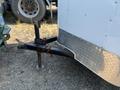 A 2020 Mirage Enterprises 12 Foot Cargo trailer with a hitch attachment and chains secured to the hitch for stability
