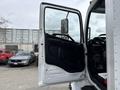 A 2017 Hino 338 truck with the driver's side door open revealing the interior dashboard and driver's seat