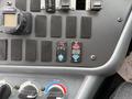 Close-up of the control panel of a 2016 International CE300 featuring switches gauges and dials for various functions including temperature and air control
