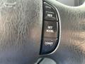 Close-up of the steering wheel controls of a 2009 Ford Econoline showing buttons for resume, set, accelerate, and coast