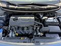 Engine compartment of a 2018 Kia Rio5 displaying the engine block battery and various components