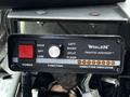 Control panel of a Whelen Traffic Advisor featuring buttons and indicator lights for high low power function and traffic direction settings