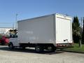 A white 2024 Chevrolet Express cargo van with a boxy body design and a closed rear door