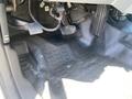 A 2015 Ford F-450 SD showing the interior floor area with the accelerator and brake pedals visible along with a rubber floor mat