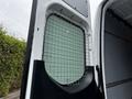 A 2019 Mercedes-Benz Sprinter with a metal grid screen installed in the rear opening of the cargo area