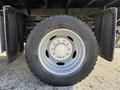 Close-up of a 2008 Ford F-550 wheel showing a silver rim with five lug bolts and a rugged black tire