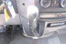 2012 Mercedes-Benz Sprinter gear shift lever with a textured black handle and surrounding controls including dashboard buttons and climate settings