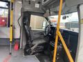 Interior view of a 2018 Chevrolet Express showing the driver's seat and dashboard with controls and steering wheel visible