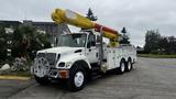 A white 2006 International 7500 utility truck with a yellow and orange aerial lift arm mounted on the cab and a tool compartment on the sides