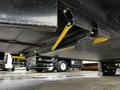 A black and yellow stabilizer mechanism mounted under a 2022 Aspen Trail trailer