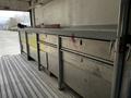 2006 GMC C5000 with multiple metal tool drawers and a long workbench surface in the foreground
