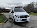 A white 2018 Mercedes-Benz Metris van parked on a street with a sleek design and prominent front grille featuring the Mercedes logo