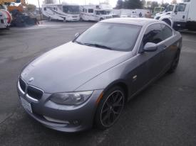 A silver 2011 BMW 3-Series coupe parked with a sleek design and sporty wheels