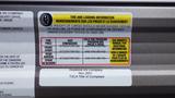A tire and loading information label attached to a 2022 Aspen Trail RV detailing weight limits and tire specifications