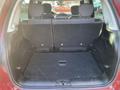 A 2015 Fiat 500L with its rear seats folded down showcasing the spacious cargo area