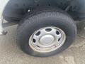 A close-up view of a tire and wheel from a 2013 Ford F-150 showing the tread pattern and metallic wheel design