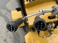 Close-up of the control levers of a 2024 AGT Industrial KRW23 Mini Loader with labeled positions for functions such as forward and reverse