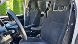 Interior of a 2016 Dodge Grand Caravan featuring two front seats and a steering wheel with a focus on the fabric upholstery and layout